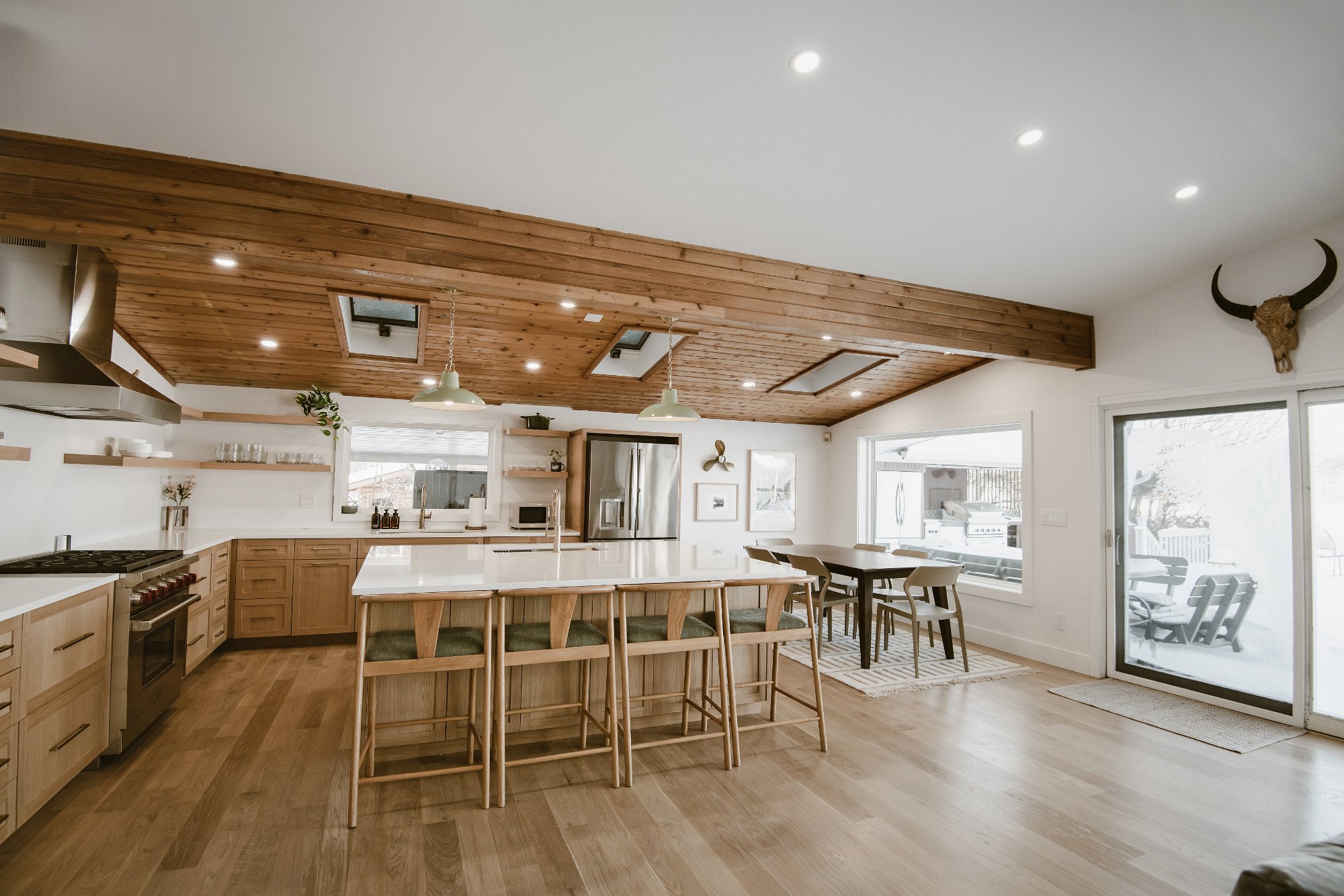 Open kitchen and dining with skylights